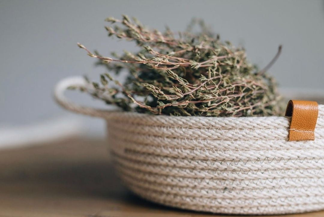 Made in Canada woven white cotton catch all bread basket with dried thyme.
