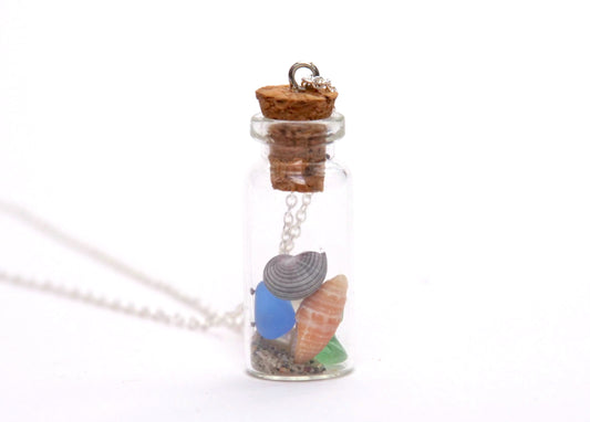 Glass bottle pendant necklace filled with colourful sea shells and beach sand. Handmade in Canada by Bridget Turner.