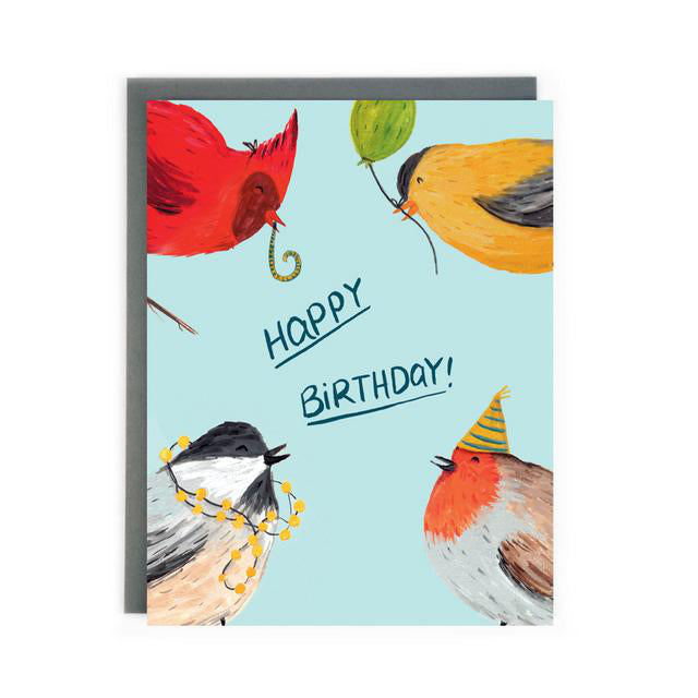 Canadian Made birthday card with a painting of a cardinal blowing a streamer, a chickadee with lights on its head, a goldfinch holding a balloon and a sparrow wearing a party hat. Caption reads: Happy Birthday!