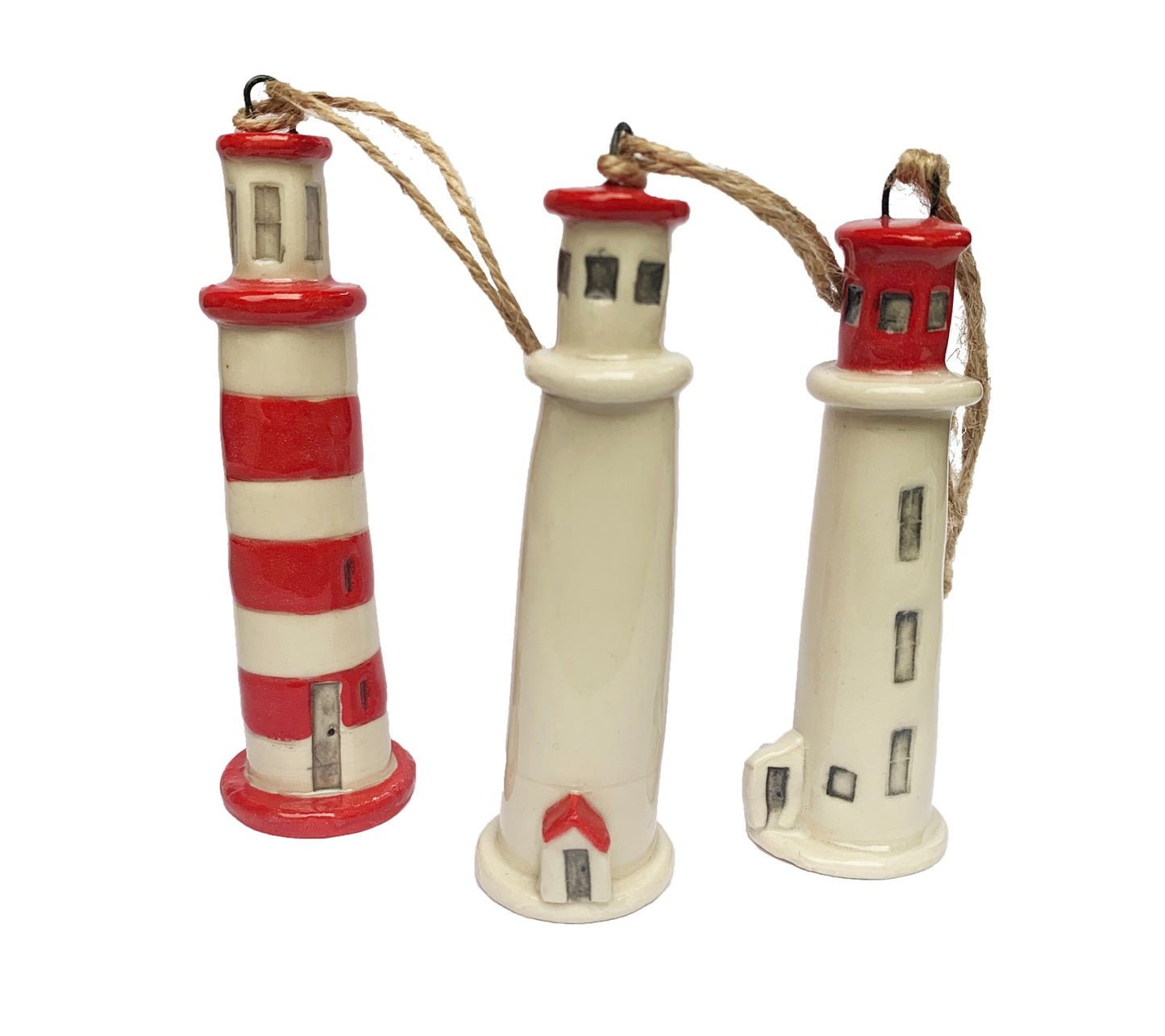 Three hand painted ceramic red and white lighthouse ornaments made in Nova Scotia, Canada.