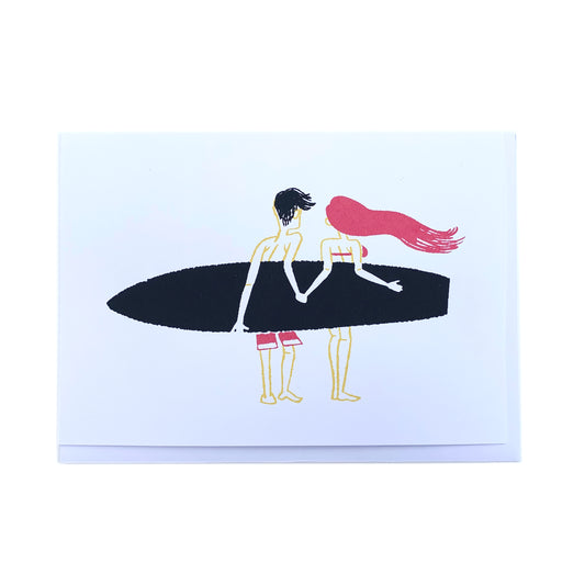 Made in Canada surfing themed love and friendship card, with silkscreen painting of two surfers holding one surfboard and holding hands. No caption.