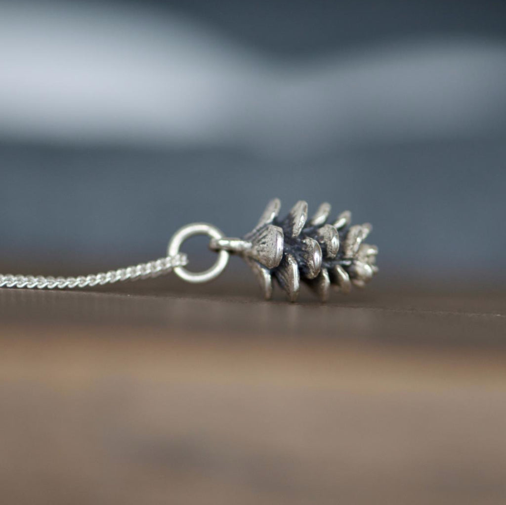 Made in Canada Justine Brooks tiny silver pinecone charm necklace.