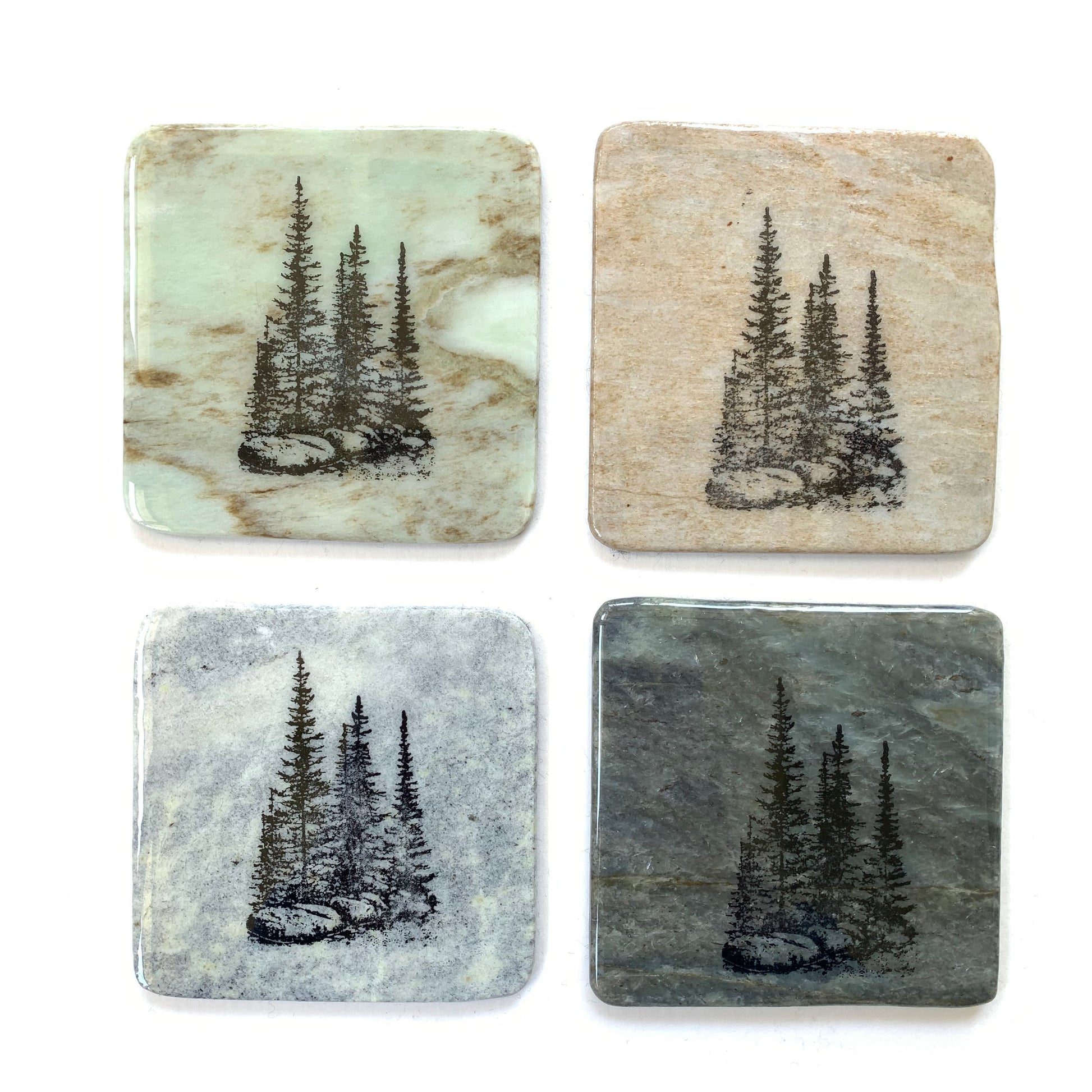 Various granite coasters with three pines design made in Canada.