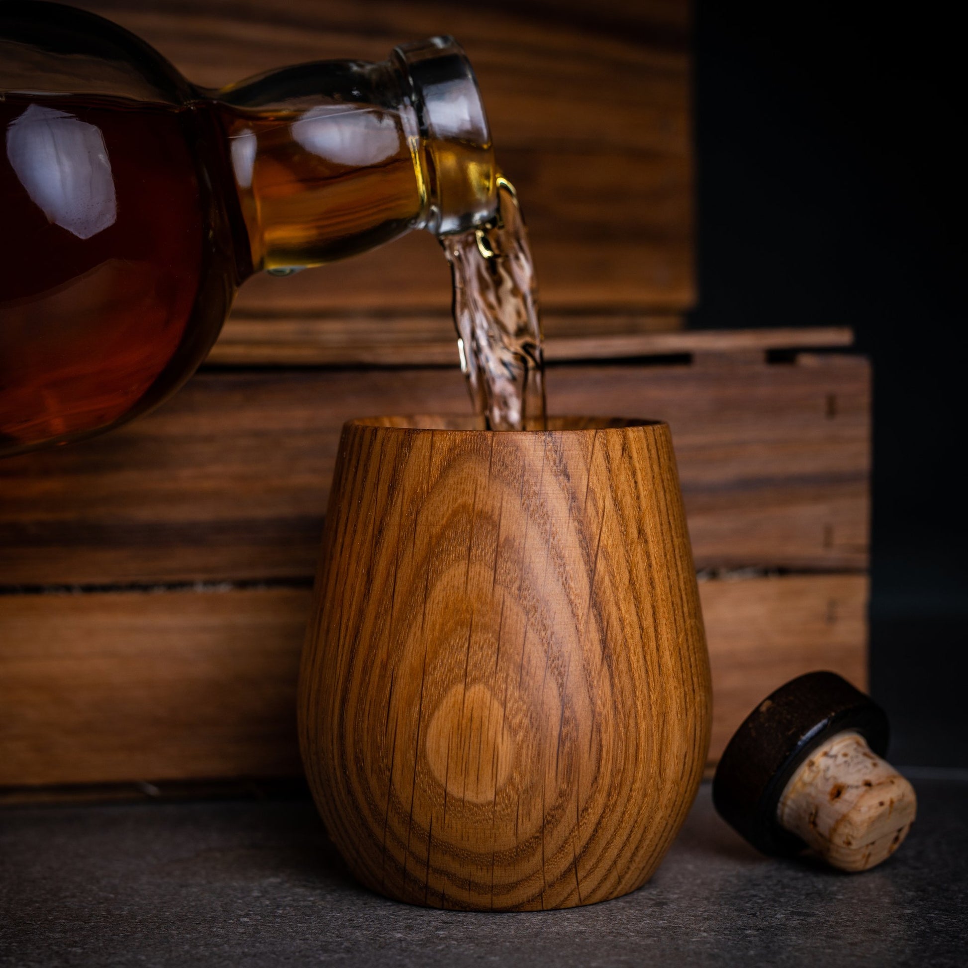 Whisky being poured into a Canadian made oak whiskey tumbler by Stinson Studios.