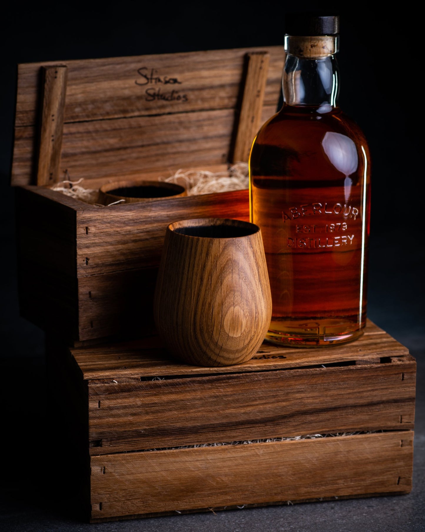 Made in Canada charred oak whiskey tumbler set by Stinson Studios with gift crates and a bottle of whisky.