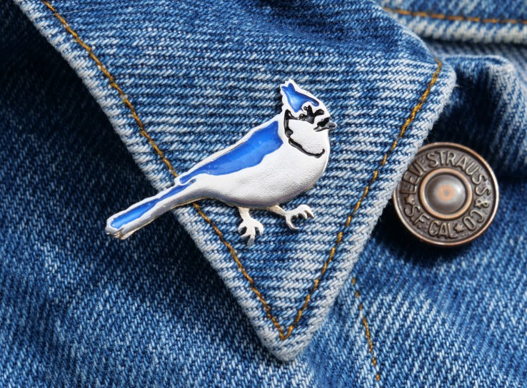 Sterling silver blue jay brooch pin with painted enamel, made in Canada by Slashpile Designs.