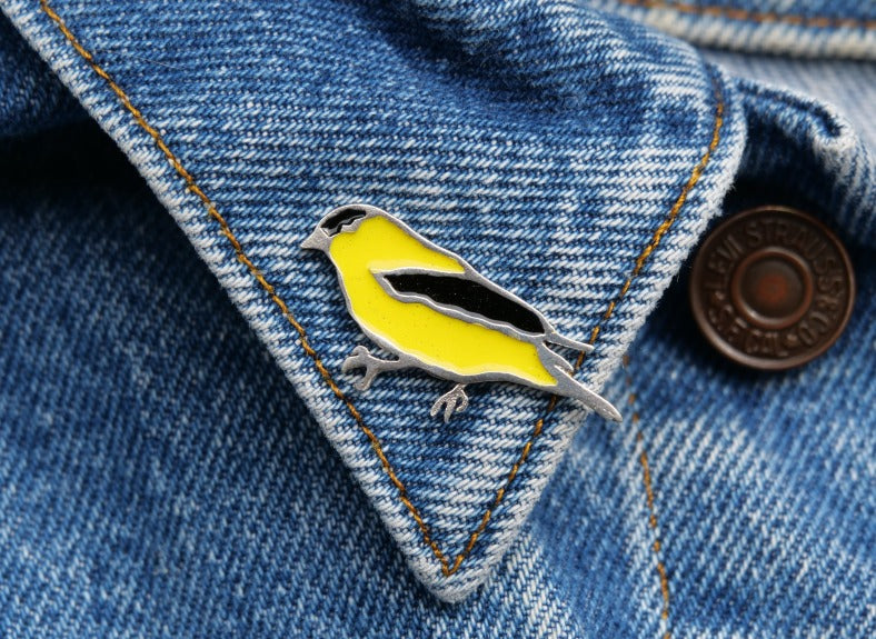Sterling silver Goldfinch brooch pin with painted enamel, made in Canada by Slashpile Designs.